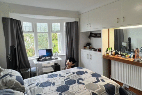 Comfortable double bedroom with essential furniture, heating, and Wi-Fi, perfect for long stays.