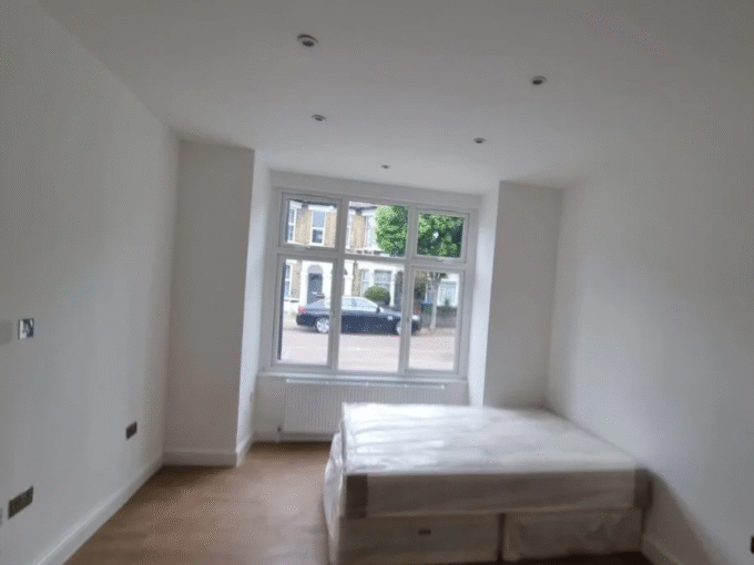 Comfortable double bedroom with essential furniture, heating, and Wi-Fi, perfect for long stays.